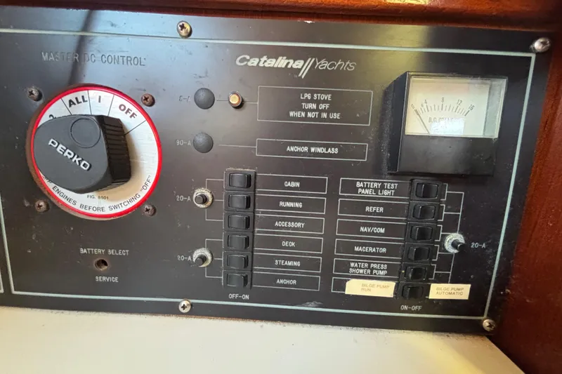 Control panel of a 1988 Catalina 34 yacht with various switches and gauges.