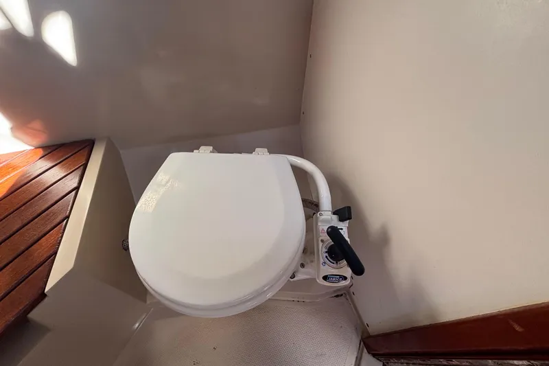 Marine toilet in 1988 Catalina 34 sailboat, featuring a manual pump handle.