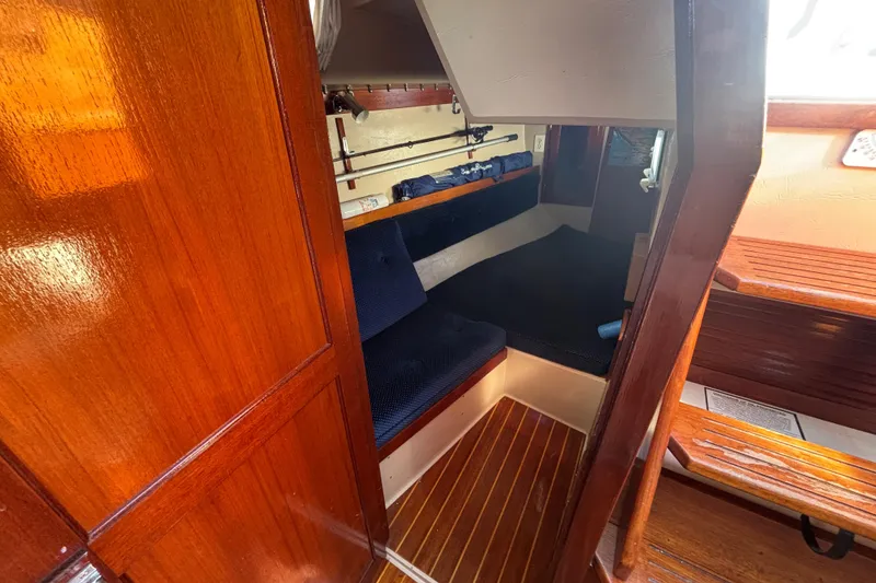 Interior of 1988 Catalina 34 sailboat with wooden finish and cozy seating area.