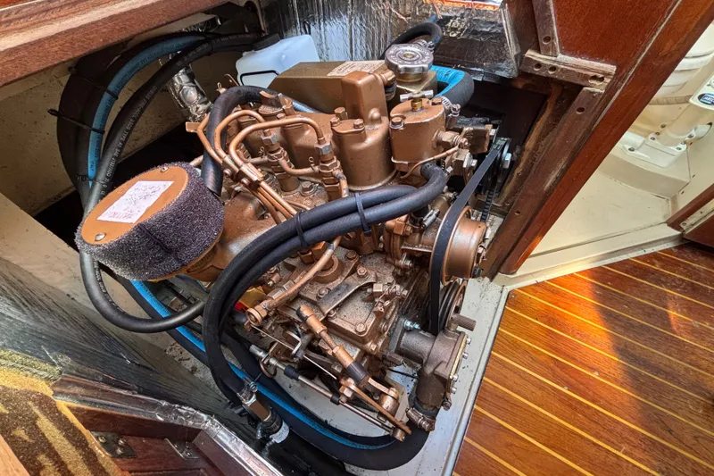 Engine compartment of a 1988 Catalina 34 sailboat, showcasing detailed mechanical components.
