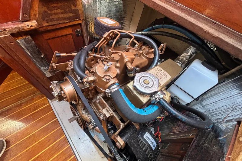 Engine compartment of a 1988 Catalina 34 sailboat, showcasing detailed mechanical components.