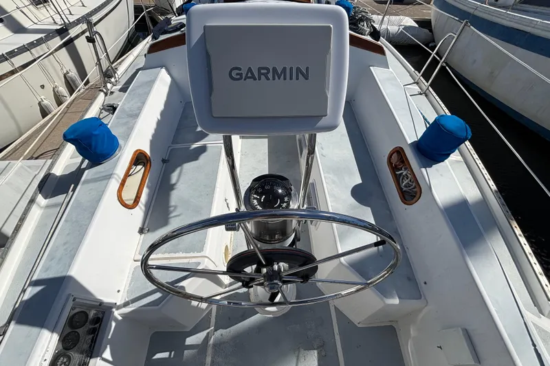 Cockpit of 1988 Catalina 34 sailboat with Garmin navigation system and steering wheel.