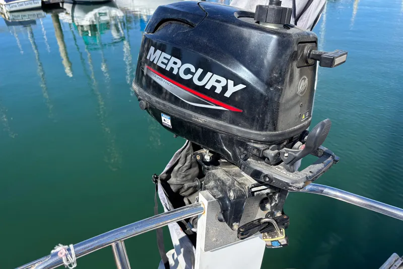 Mercury outboard motor on 1988 Catalina 34 sailboat, docked in marina.