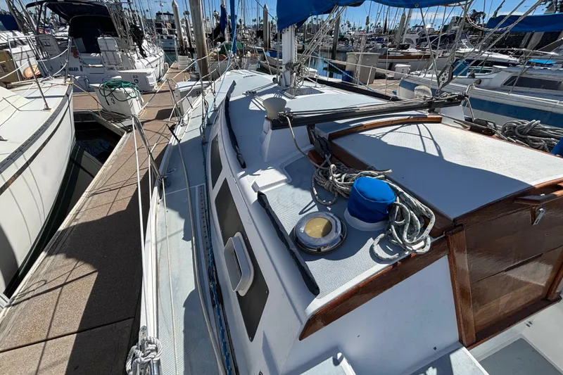 1988 Catalina 34 sailboat docked, featuring deck details and rigging in a marina setting.