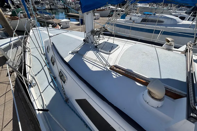 1988 Catalina 34 sailboat docked at marina, showcasing deck and rigging.