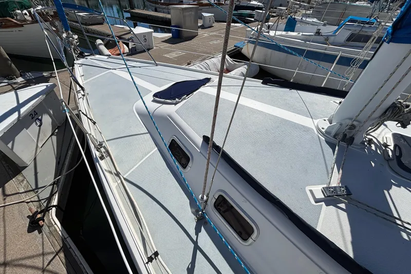 1988 Catalina 34 sailboat docked, showcasing deck and rigging details.