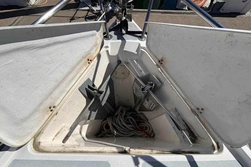 Anchor locker of 1988 Catalina 34 sailboat with rope and anchor inside.