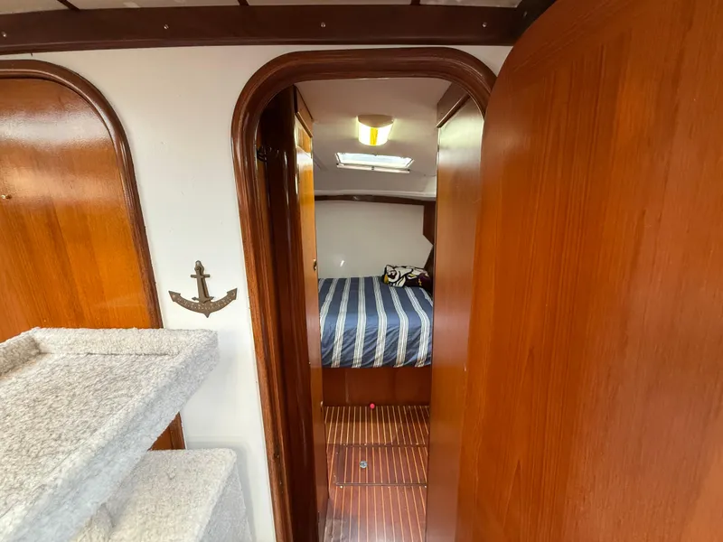 Interior of 1986 Beneteau Idylle 15.50 yacht with wood paneling and cozy cabin.