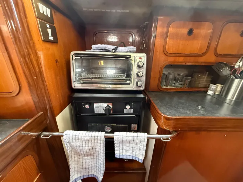 Galley kitchen in 1986 Beneteau Idylle 15.50 sailboat with oven and toaster.