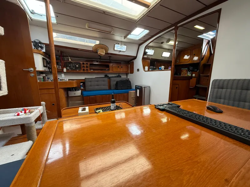 Interior of 1986 Beneteau Idylle 15.50 sailboat with wooden furnishings and seating area.