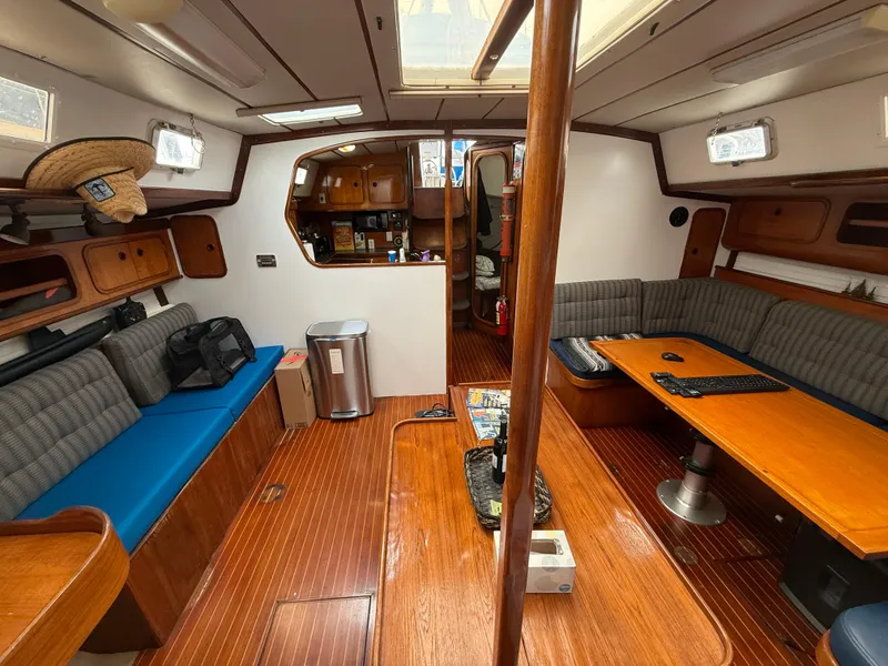 Interior of 1986 Beneteau Idylle 15.50 sailboat with wood finish and seating area.