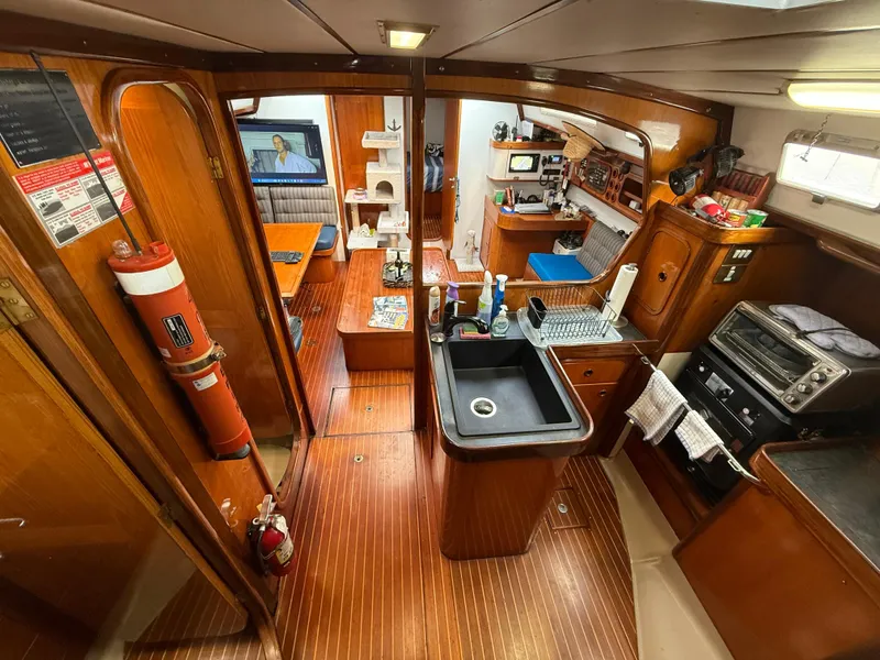 Interior of 1986 Beneteau Idylle 15.50 yacht with kitchen and living area.