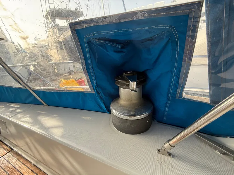 Winch on 1986 Beneteau Idylle 15.50 sailboat, covered with blue fabric.