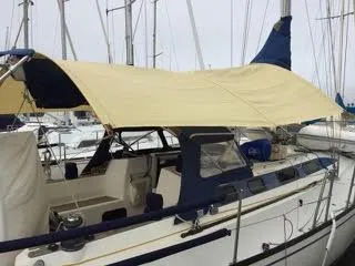 2002 X-Yachts X-382 sailboat with canopy, docked in a marina.