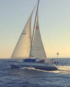 Sailing yacht X-Yachts X-382, 2002 model, gliding on open sea under clear skies.