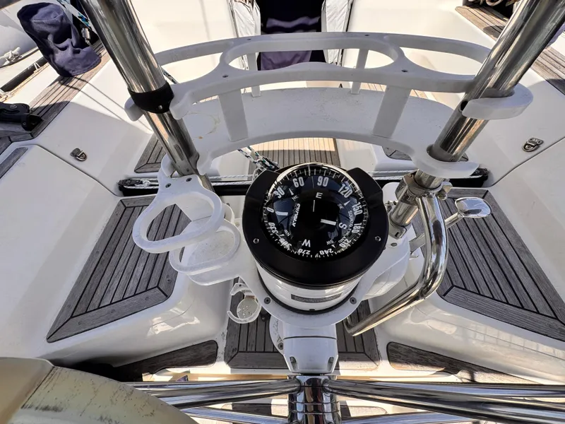 Compass on 2002 X-Yachts X-382 sailboat, surrounded by sleek deck and metal railings.
