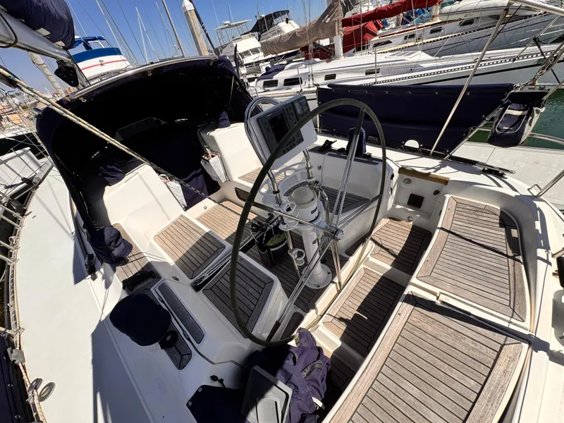 Cockpit of 2002 X-Yachts X-382 sailboat with wooden seating and steering wheel.