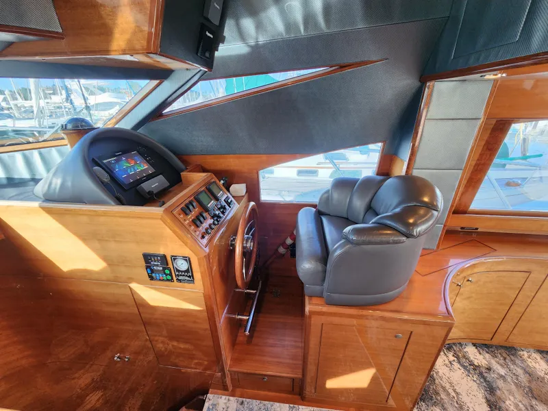 2007 Ocean Alexander Veloce helm with leather seat, wooden dashboard, and modern navigation controls.