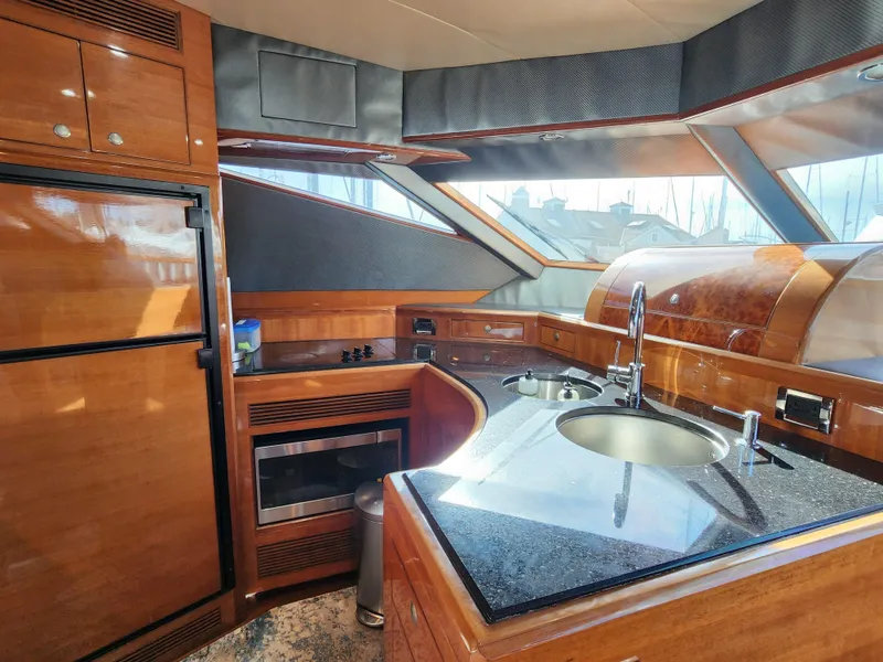 Luxurious 2007 Ocean Alexander Veloce yacht kitchen with modern amenities and sleek wood finishes.