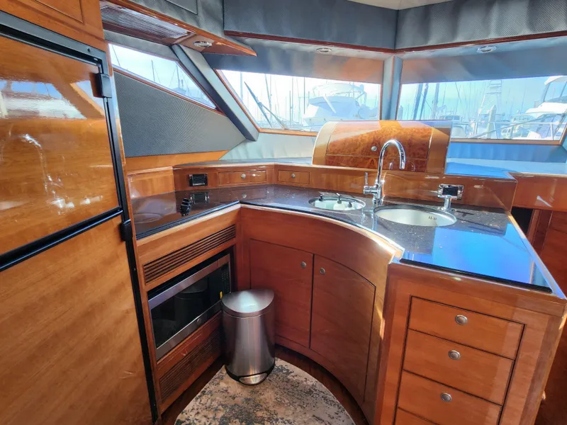 Luxurious 2007 Ocean Alexander Veloce yacht kitchen with wood cabinetry and modern appliances.