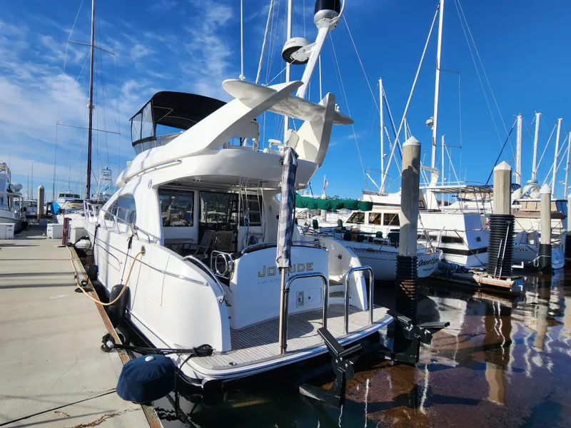 2007 Ocean Alexander Veloce yacht docked at marina under clear blue sky.