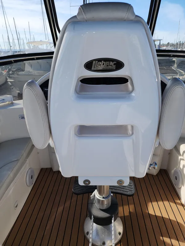 Captain's chair on 2007 Ocean Alexander Veloce yacht with teak flooring.