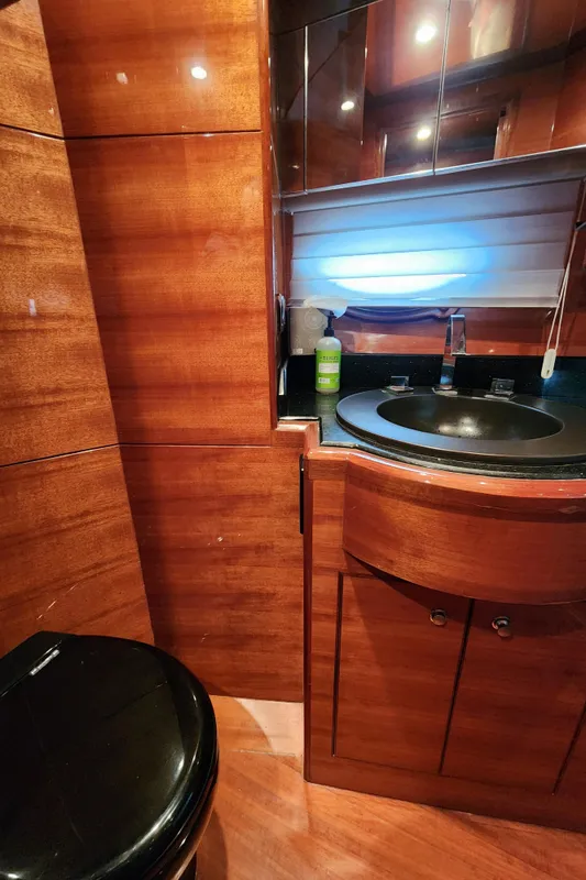 Luxurious 2007 Ocean Alexander Veloce yacht bathroom with wood paneling and modern fixtures.