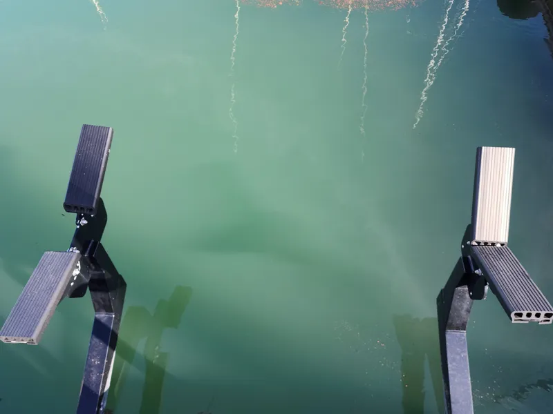 Boat lift supports over green water, Ocean Alexander Veloce 2007.