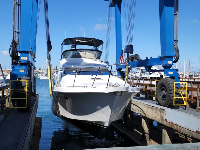 Ocean Alexander Veloce 2007 yacht in dry dock, blue sky, marina background.