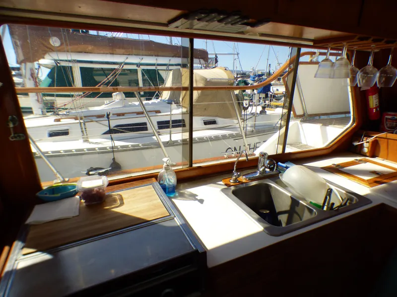 Interior view of 1984 Spindrift 39 ft. yacht kitchen with marina backdrop.