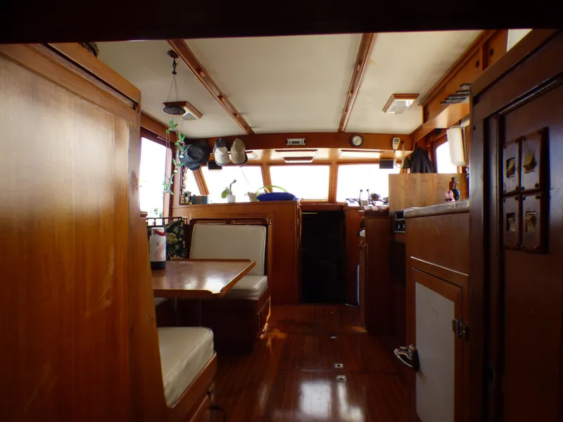 Interior of 1984 Spindrift 39 ft. Aft Cabin Twin Diesel yacht, featuring wood paneling and seating.