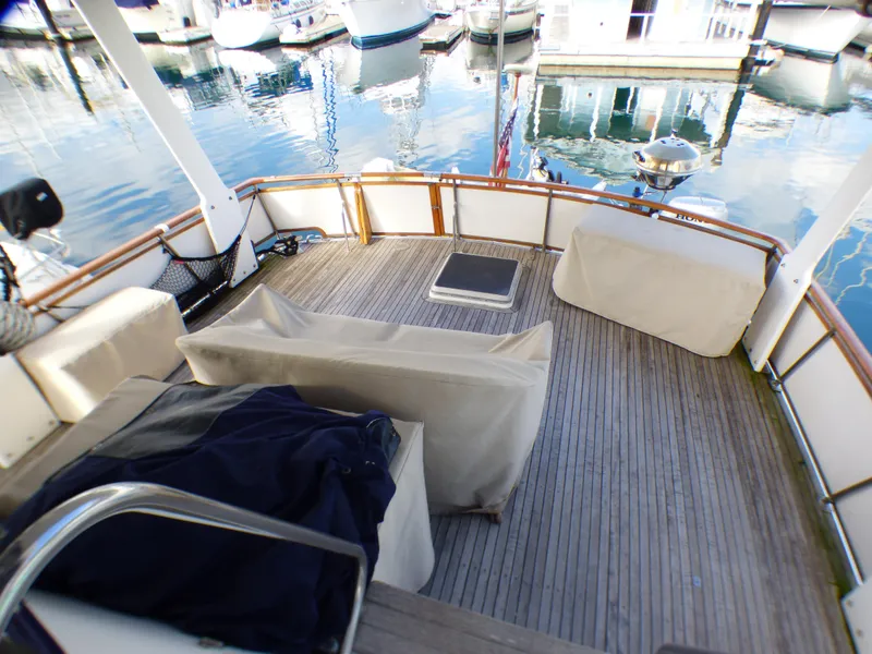 1984 Spindrift 39 ft. aft cabin deck with covered seating and marina view.