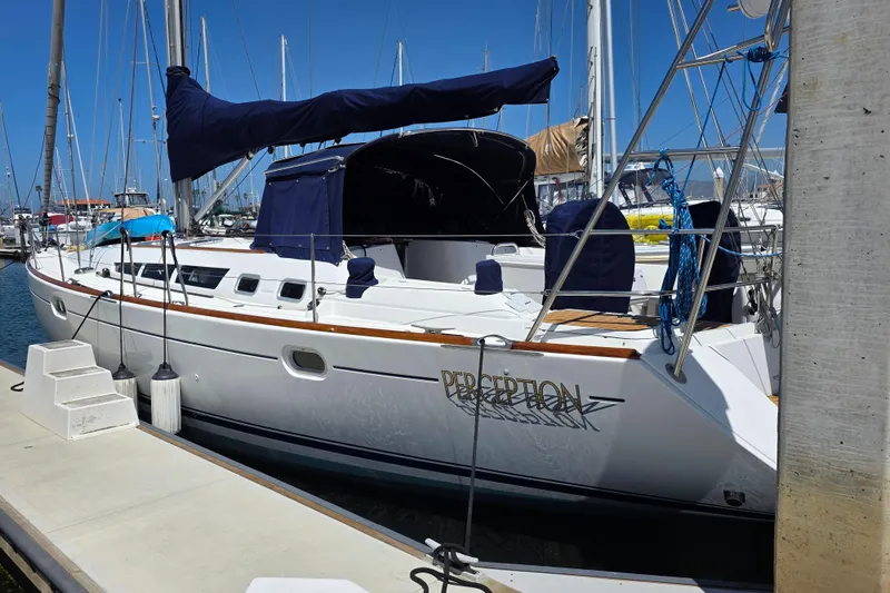 2007 Jeanneau 49 Performance sailboat docked at marina under clear blue sky.