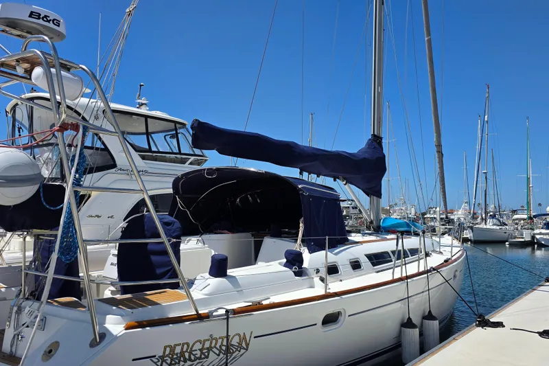 2007 Jeanneau 49 Performance sailboat docked at a marina under clear blue skies.