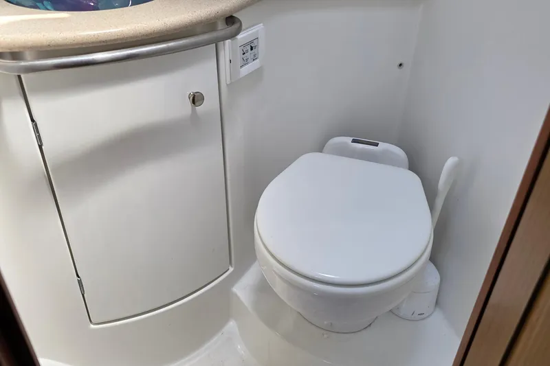 Compact bathroom on 2007 Jeanneau 49 Performance yacht, featuring a modern toilet and storage cabinet.