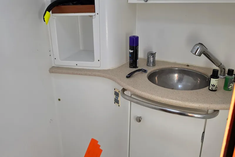 Bathroom sink area on a 2007 Jeanneau 49 Performance yacht with toiletries.