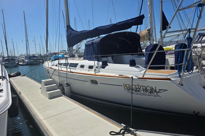 2007 Jeanneau 49 Performance sailboat docked at a marina under clear blue skies.