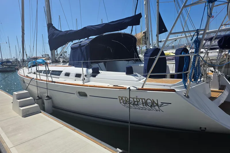 2007 Jeanneau 49 Performance sailboat docked at marina under clear blue sky.