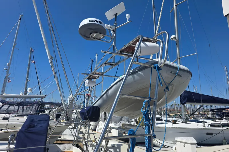 Sailboat Jeanneau 49 Performance 2007 with dinghy and radar, docked in marina.