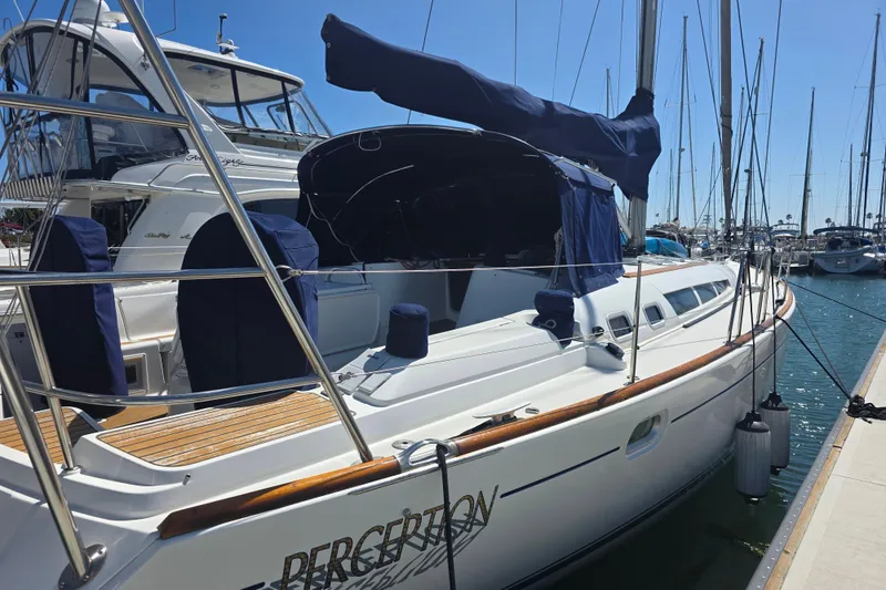 2007 Jeanneau 49 Performance sailboat docked at marina under clear blue sky.