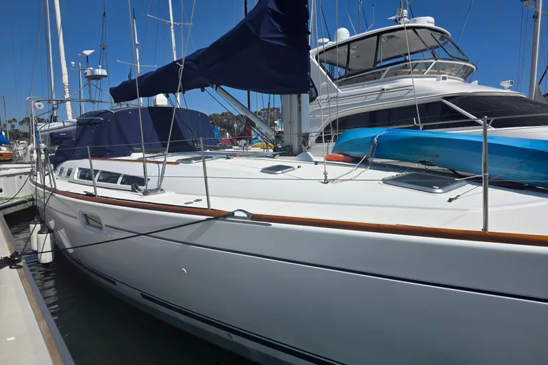 2007 Jeanneau 49 Performance sailboat docked at marina under clear blue sky.