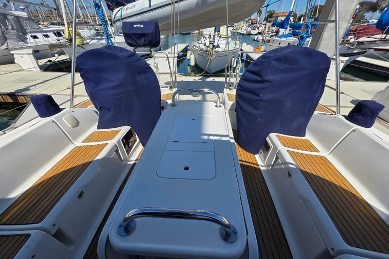 2007 Jeanneau 49 Performance yacht cockpit with covered steering wheels and teak flooring.