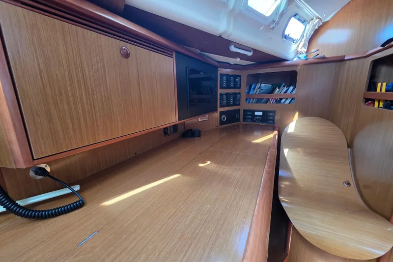 2007 Jeanneau 49 Performance yacht interior with wooden cabinetry and navigation station.