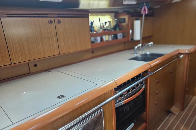 2007 Jeanneau 49 Performance yacht kitchen with wooden cabinets and modern appliances.