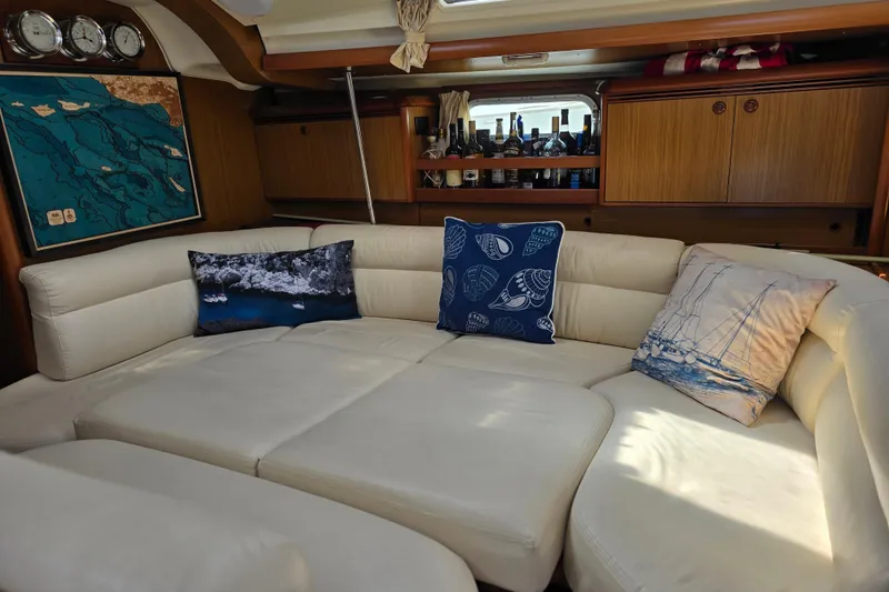 Luxurious interior of 2007 Jeanneau 49 Performance yacht with plush seating and nautical decor.