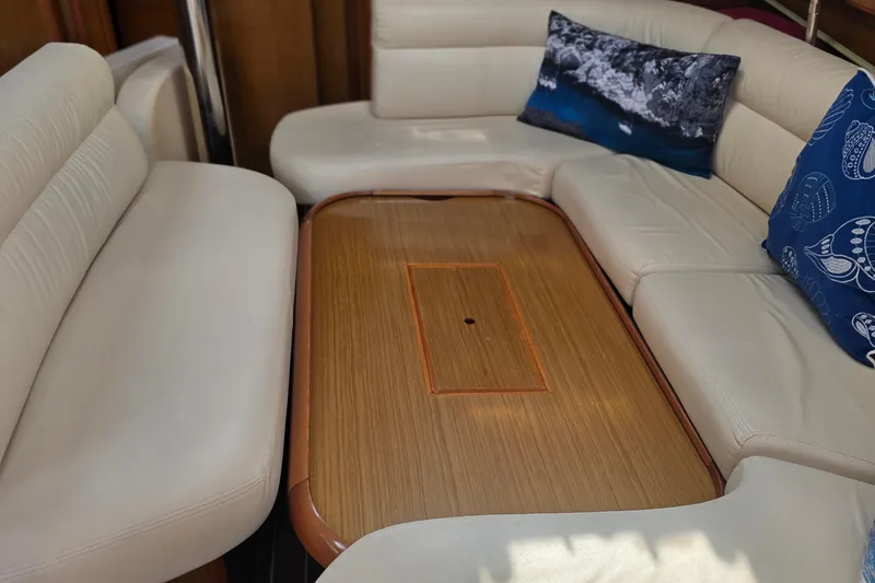 Luxurious interior of 2007 Jeanneau 49 Performance yacht with elegant seating and wooden table.