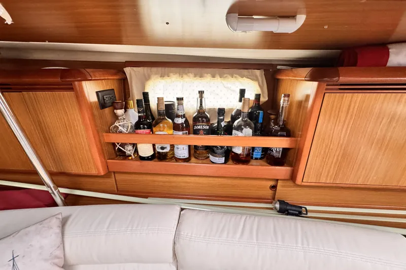 Interior of 2007 Jeanneau Sun Odyssey 49 Performance with liquor shelf and wooden cabinetry.