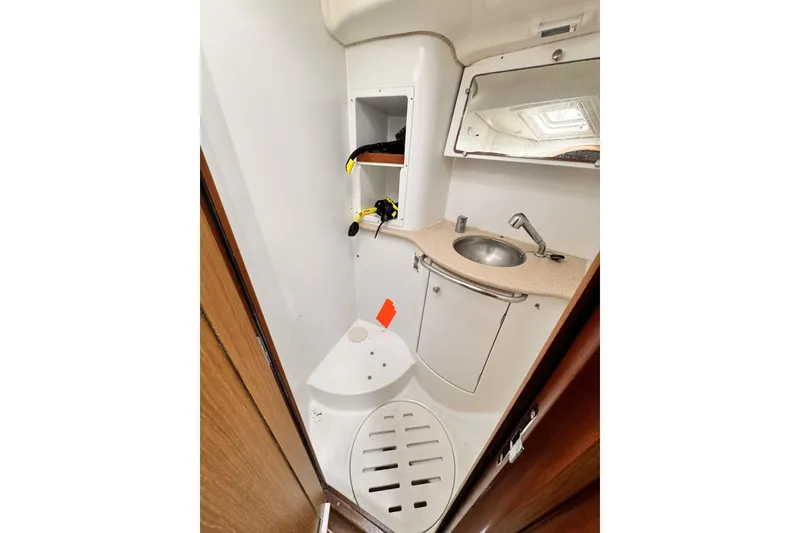 Compact bathroom in 2007 Jeanneau Sun Odyssey 49 Performance yacht, featuring sink and storage.