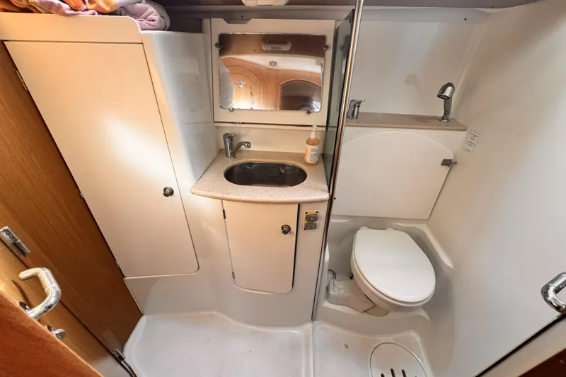 2007 Jeanneau Sun Odyssey 49 Performance yacht bathroom with sink, mirror, and toilet.