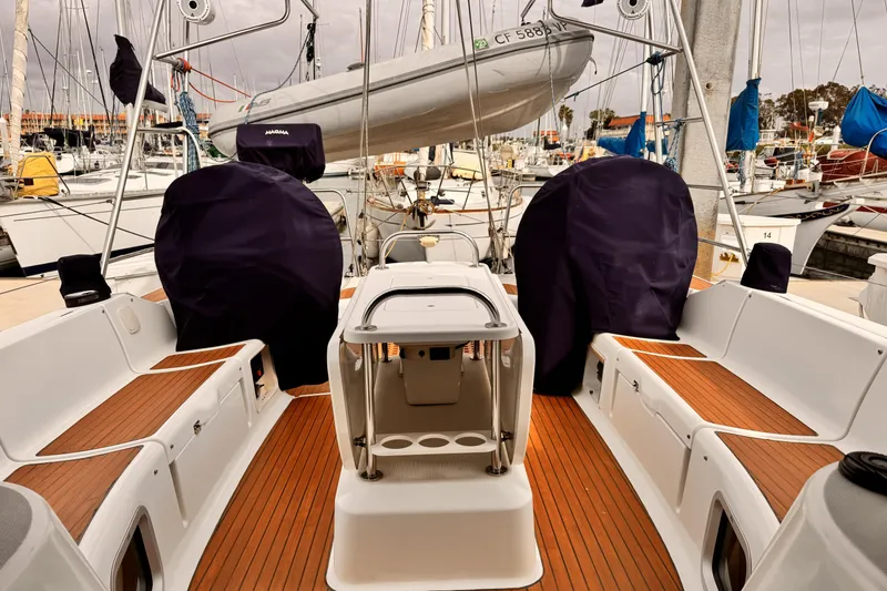 2007 Jeanneau Sun Odyssey 49 Performance sailboat cockpit with covered equipment and wooden deck.
